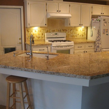 Juparana Granite counter-top with a rhomboid onyx back-splash