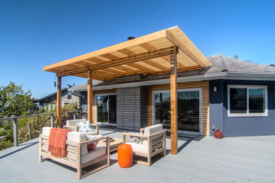 Example of a 1950s backyard deck container garden design in San Luis Obispo with a pergola