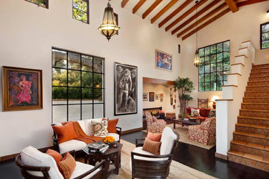 Example of an open concept dark wood floor living room design in Santa Barbara with white walls