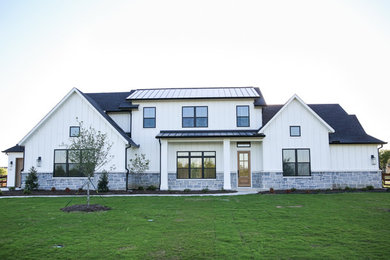 Large farmhouse white two-story mixed siding exterior home photo in Dallas with a shingle roof