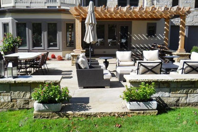Elegant backyard stone patio photo in Cleveland