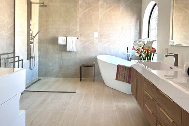 Bathroom - large modern master brown tile and porcelain tile wood-look tile floor, brown floor and double-sink bathroom idea in Miami with flat-panel cabinets, medium tone wood cabinets, white walls, an integrated sink, solid surface countertops, white countertops and a floating vanity