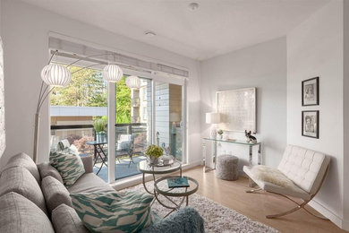 Living room - small contemporary open concept medium tone wood floor and brown floor living room idea in Vancouver with white walls, no fireplace and no tv