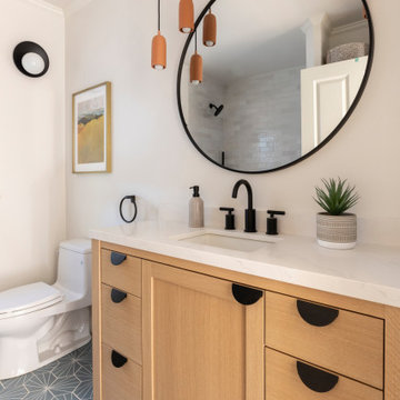 Bathroom with Terracotta Colored Pendants, Black Fixtures, and Blue Hexagon Floo