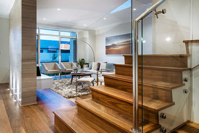 Beach style wood u-shaped staircase in Perth with wood risers and metal railing.