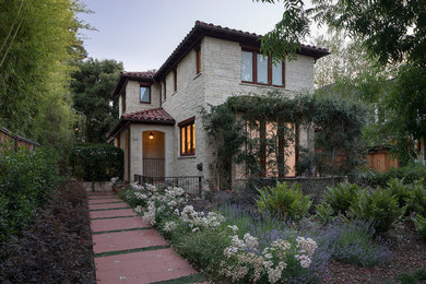 Large tuscan brown three-story stone exterior home photo in San Francisco with a hip roof