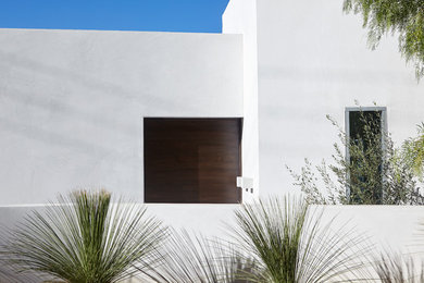 Mid-sized modern white two-story stucco exterior home idea in Los Angeles