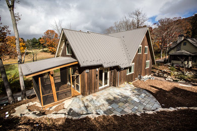 Mid-sized modern brown two-story mixed siding gable roof idea in Other