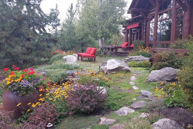 Inspiration for a large traditional partial sun backyard stone landscaping in Other for summer.