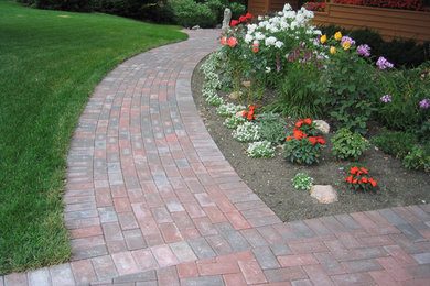 Inspiration for a mid-sized transitional front yard garden in Minneapolis with a garden path and brick pavers.