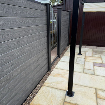 Charcoal Composite Fence Panels Beside a Sandstone Patio