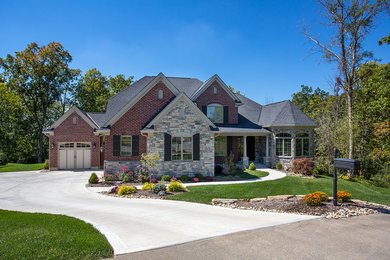 Inspiration for a large timeless multicolored two-story exterior home remodel in Cincinnati with a hip roof