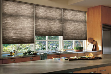 Example of a mid-sized trendy single-wall kitchen design in Other with flat-panel cabinets, light wood cabinets, concrete countertops, stainless steel appliances, an island and gray countertops
