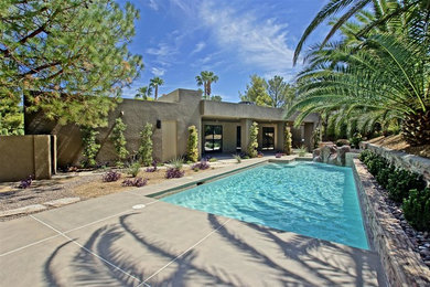 Mid-sized transitional backyard concrete and rectangular pool photo in Las Vegas