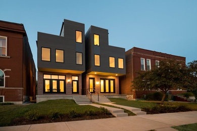 Photo of a large contemporary three-storey house exterior in St Louis with metal siding.