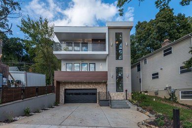 Inspiration for a large contemporary gray three-story mixed siding flat roof remodel in DC Metro