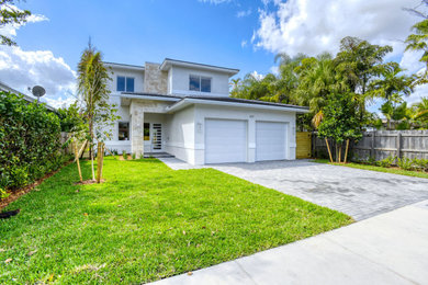 Inspiration for a large transitional white two-story stucco house exterior remodel in Miami with a hip roof, a tile roof and a brown roof