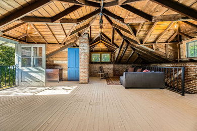 Inspiration for a small craftsman medium tone wood floor, white floor, vaulted ceiling and brick wall study room remodel in Denver with red walls