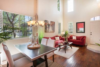 Example of a large transitional open concept medium tone wood floor and brown floor living room design in Orange County with white walls, no fireplace and no tv