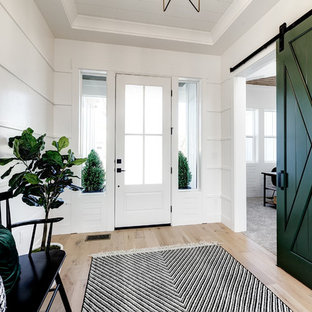 Inspiration for a mid-sized country foyer in Boise with white walls, light hardwood floors, a single front door, a white front door and beige floor.