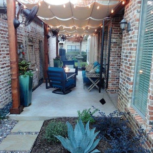 Photo of a small transitional side yard patio in Dallas with a fire feature, concrete pavers and an awning.