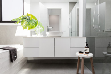 Contemporary bathroom in Melbourne with flat-panel cabinets, white cabinets, an alcove shower, white tile, white walls, a vessel sink, grey floor, grey benchtops, a single vanity and a floating vanity.