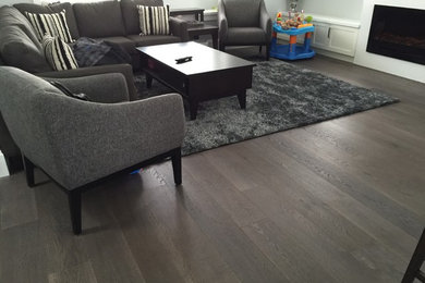 Living room - large contemporary formal and open concept dark wood floor living room idea in Vancouver with white walls, a standard fireplace and no tv