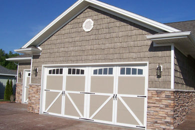 Garage - mid-sized attached two-car garage idea in Omaha