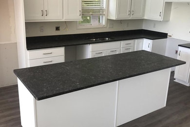 Example of a transitional kitchen design in Atlanta with shaker cabinets, white cabinets, granite countertops, an island and gray countertops