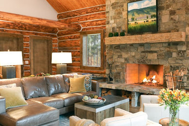 Example of a mid-sized mountain style formal and open concept medium tone wood floor and brown floor living room design in Other with brown walls, a standard fireplace, a stone fireplace and no tv