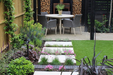 Inspiration for a small contemporary backyard partial sun formal garden for summer in Hampshire with decking.