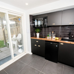 Photo of a medium sized contemporary walk-out basement in Toronto with white walls, laminate floors, no fireplace and white floors.