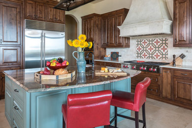 Open concept kitchen - large mediterranean u-shaped porcelain tile and beige floor open concept kitchen idea in Austin with raised-panel cabinets, dark wood cabinets, granite countertops, multicolored backsplash, subway tile backsplash, stainless steel appliances, an island and multicolored countertops