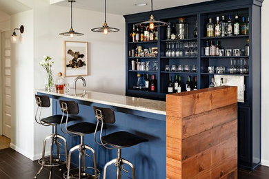 Design ideas for a large transitional galley seated home bar in Portland with open cabinets, blue cabinets, granite benchtops, dark hardwood floors and brown floor.