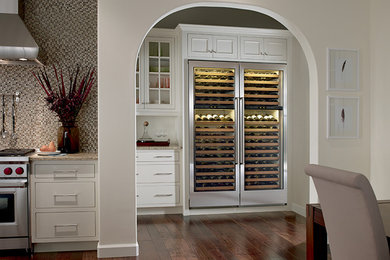 Design ideas for a small transitional wine cellar in Portland with dark hardwood floors, display racks and brown floor.