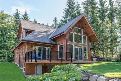 Mountain style two-story wood exterior home photo in Vancouver
