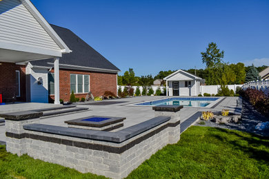 Inspiration for a large timeless backyard brick and rectangular pool landscaping remodel in Detroit