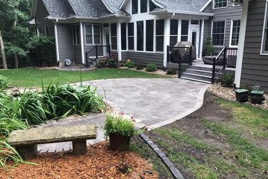 Inspiration for a small backyard stone patio remodel in Cedar Rapids