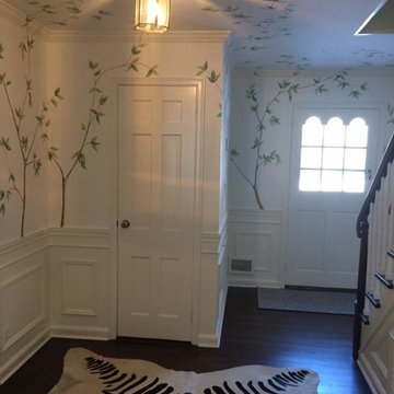 Hand painted tree branches with Magnolia flowers on walls in foyer