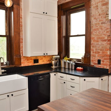 Bourbon, IN. Haas Signature Collection. Farmhouse Kitchen with Exposed Brick