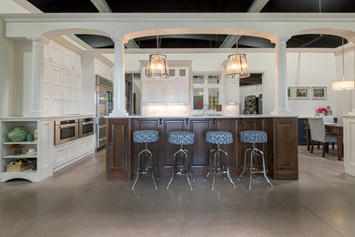 Open concept kitchen - large traditional galley open concept kitchen idea in Other with recessed-panel cabinets, white cabinets, quartz countertops, gray backsplash, marble backsplash, stainless steel appliances, an island and an undermount sink