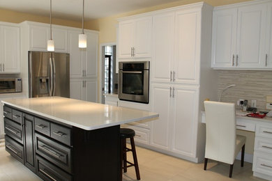 Photo of a large transitional u-shaped eat-in kitchen in Vancouver with raised-panel cabinets, white cabinets, quartz benchtops, multi-coloured splashback, matchstick tile splashback, stainless steel appliances, porcelain floors and with island.
