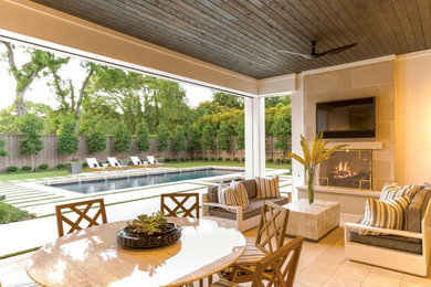 Mediterranean backyard patio in Dallas with with fireplace and a roof extension.