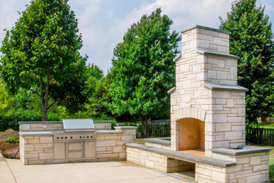 Inspiration for a traditional backyard stone landscaping in Chicago with a fireplace.