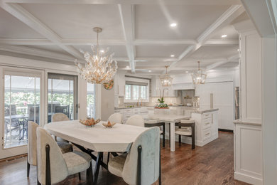 Large minimalist medium tone wood floor, brown floor and coffered ceiling eat-in kitchen photo in Other with a farmhouse sink, shaker cabinets, white cabinets, quartzite countertops, multicolored backsplash, stone slab backsplash, stainless steel appliances, an island and multicolored countertops