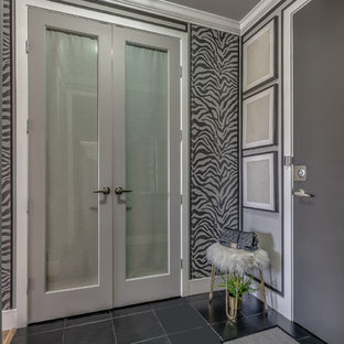 Design ideas for a mid-sized eclectic foyer in Vancouver with grey walls, travertine floors, black floor, a single front door and a gray front door.