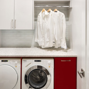 Small modern utility room in Vancouver with flat-panel cabinets, red cabinets, engineered stone countertops, white walls, porcelain flooring and a side by side washer and dryer.