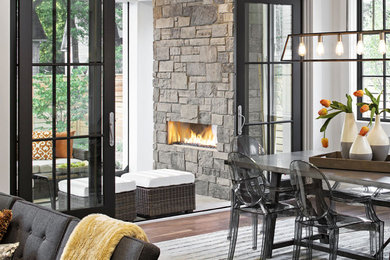 Dining room - contemporary dark wood floor dining room idea in Columbus with gray walls, a stone fireplace and a ribbon fireplace