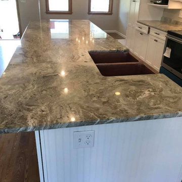 White Kitchen Cabinets with a Fantasy Brown Granite Countertop