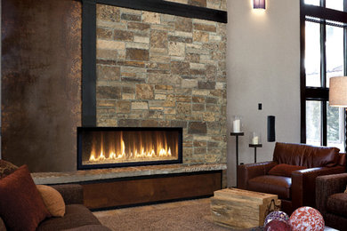 This is an example of a mid-sized transitional family room in San Francisco with grey walls, slate floors, a ribbon fireplace, a stone fireplace surround, no tv and grey floor.